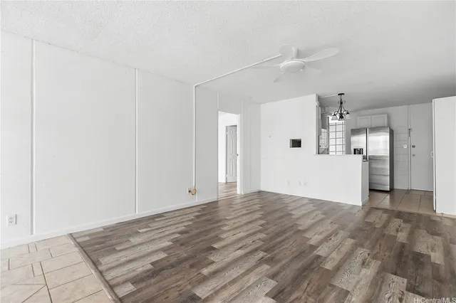 a view of a big room with wooden cabinet and windows