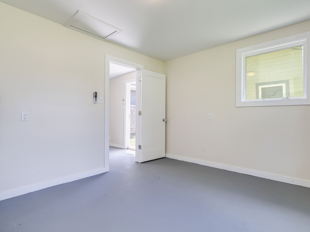 2314 Santa Rosa Street Austin, TX 78702 - Photo 15 of 27 Empty room featuring finished concrete floors and baseboards