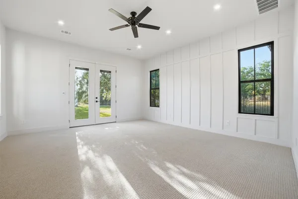 a view of a livingroom with a ceiling fan and window