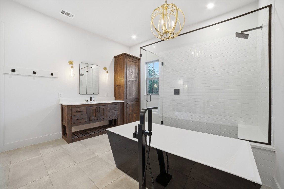 23937 Oscar Road Spicewood, TX 78669 - Photo 17 of 36 a spacious bathroom with a tub a sink and a shower