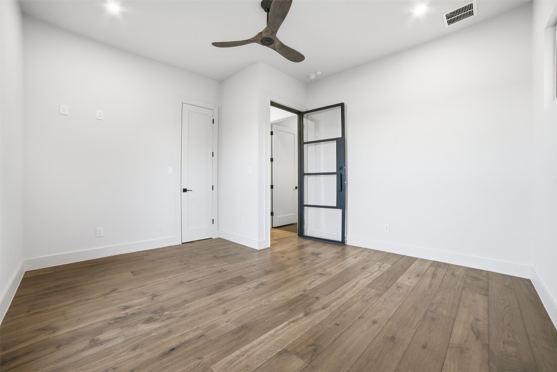 23937 Oscar Road Spicewood, TX 78669 - Photo 20 of 36 a view of an empty room with wooden floor