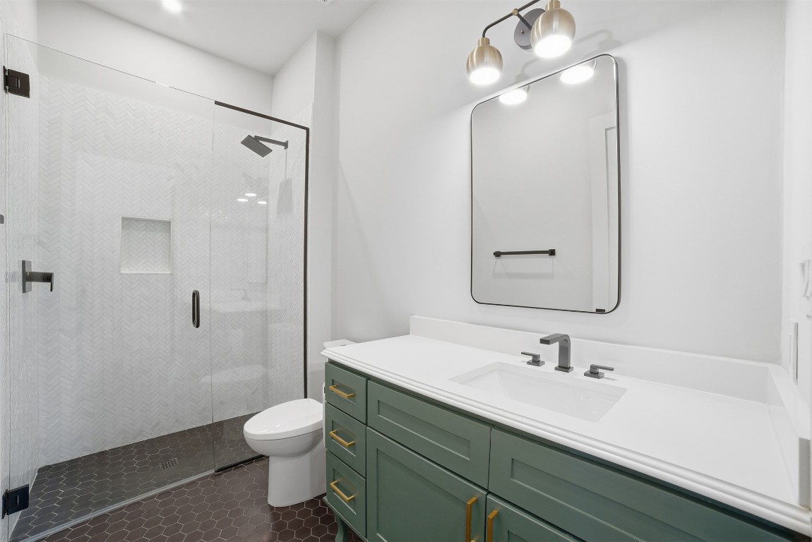 23937 Oscar Road Spicewood, TX 78669 - Photo 21 of 36 a bathroom with a sink a toilet and shower