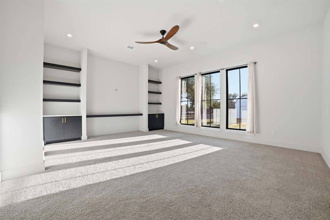 23937 Oscar Road Spicewood, TX 78669 - Photo 23 of 36 a view of an empty room with a window and a ceiling fan