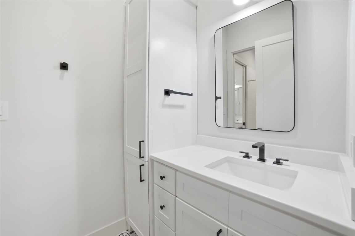 23937 Oscar Road Spicewood, TX 78669 - Photo 26 of 36 a bathroom with a sink and a mirror