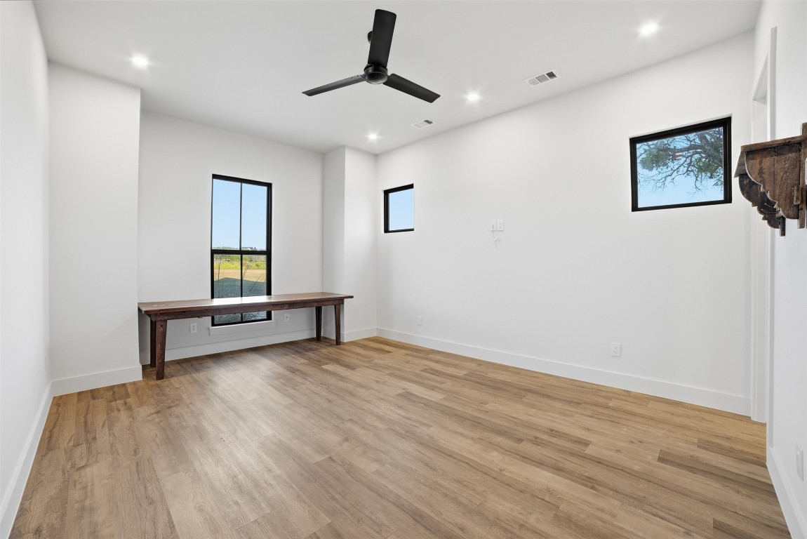 23937 Oscar Road Spicewood, TX 78669 - Photo 29 of 36 a view of room with wooden floor and ceiling fan