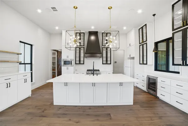 a view of an empty room with a window and a chandelier