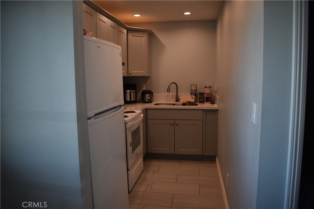20511 Memory Apple Valley, CA 92308 - Photo 14 of 23 a utility room with cabinets washer and dryer