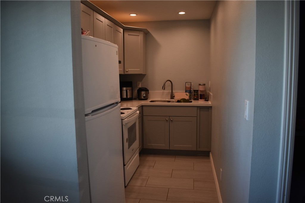 20511 Memory Apple Valley, CA 92308 - Photo 15 of 23 a utility room with cabinets washer and dryer