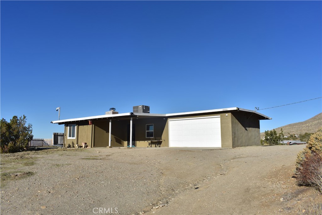 20511 Memory Apple Valley, CA 92308 - Photo 2 of 23 a front view of a house with a yard and garage