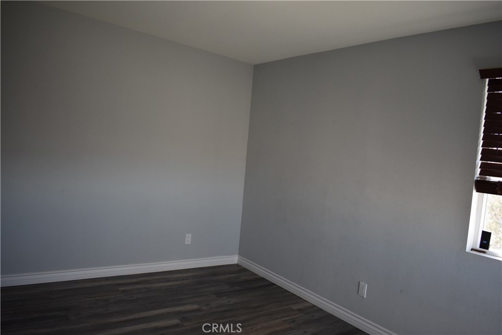 20511 Memory Apple Valley, CA 92308 - Photo 22 of 23 a view of an empty room with wooden floor and a window