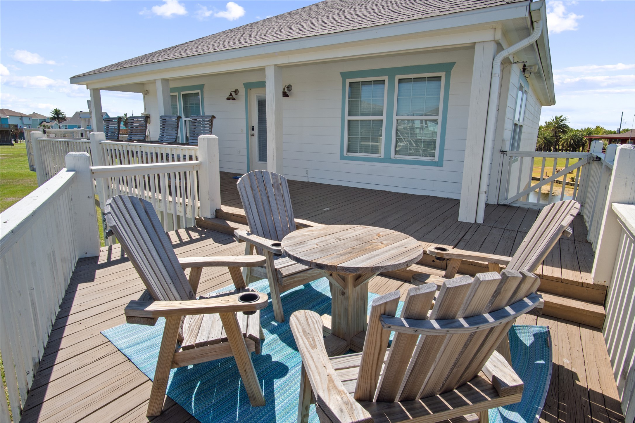 2371 Sandman Crystal Beach, TX 77650 - Photo 11 of 38 a view of a patio with table and chairs with wooden floor and fence