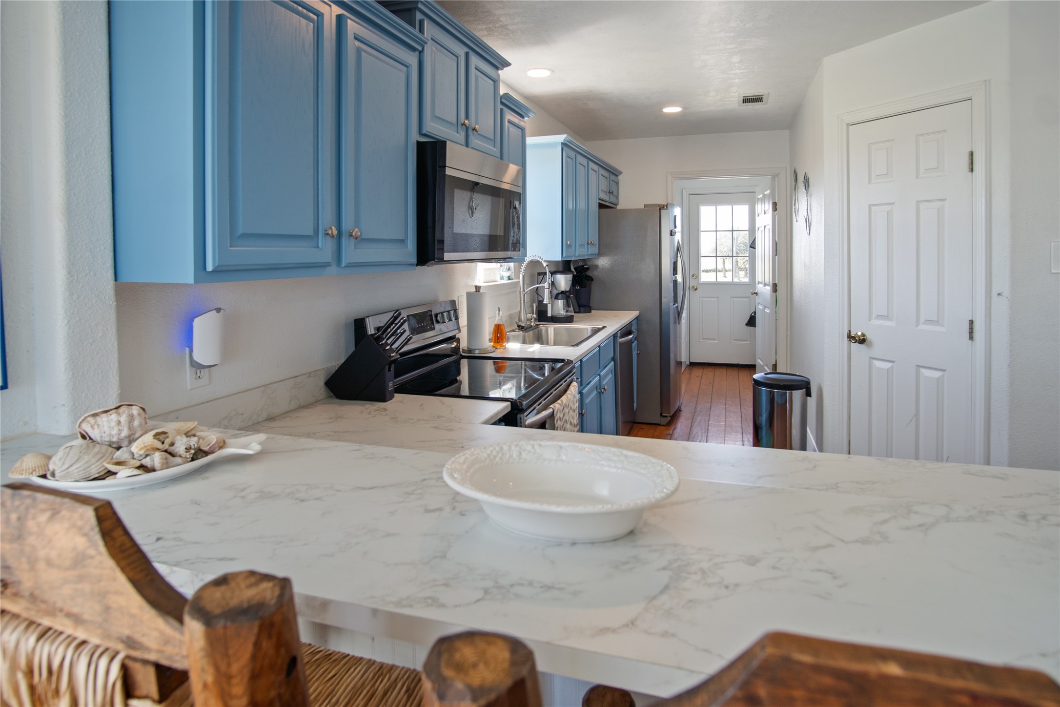 2371 Sandman Crystal Beach, TX 77650 - Photo 17 of 38 a kitchen with stainless steel appliances granite countertop a sink a stove and a microwave