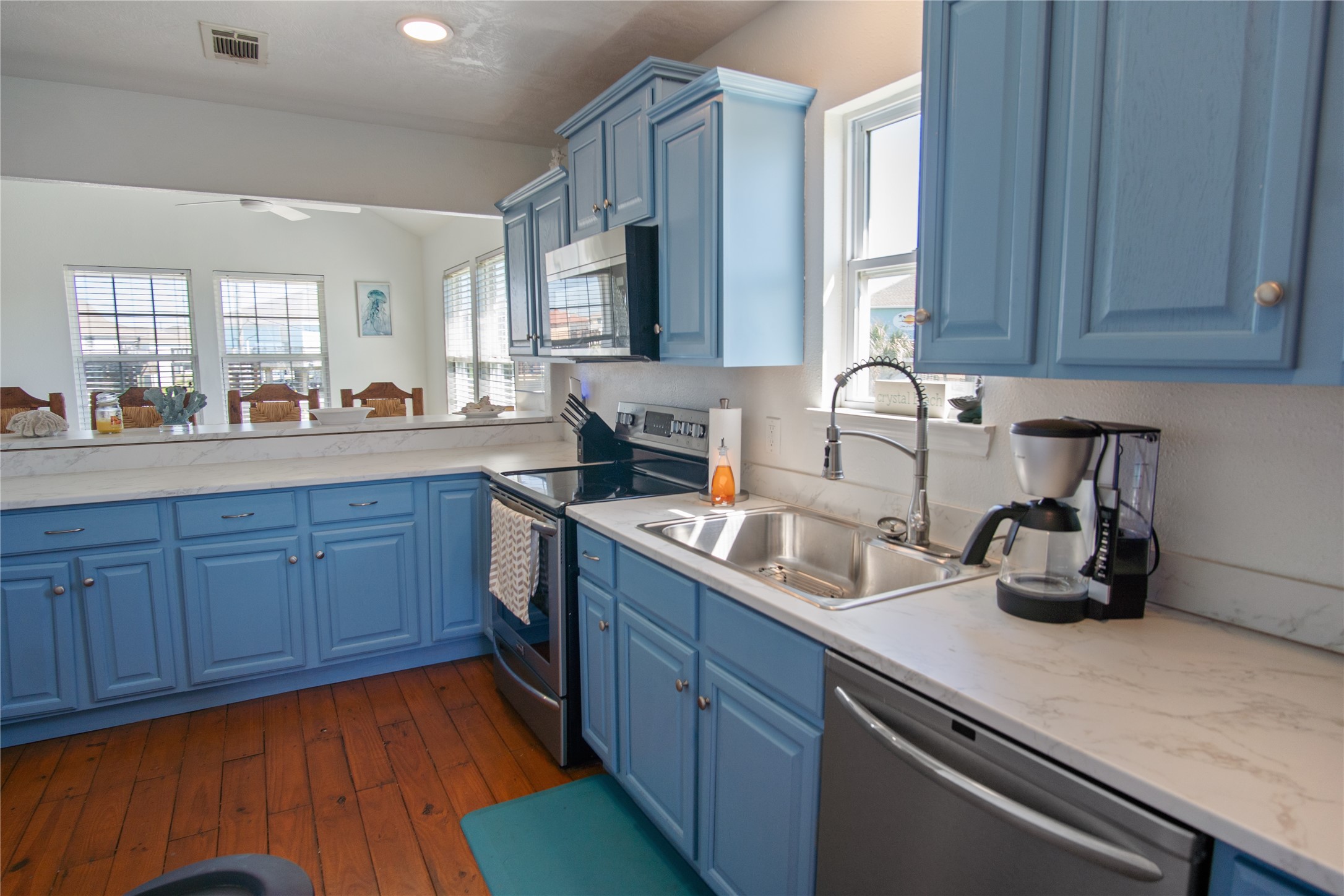 2371 Sandman Crystal Beach, TX 77650 - Photo 18 of 38 a kitchen with sink a window and cabinets