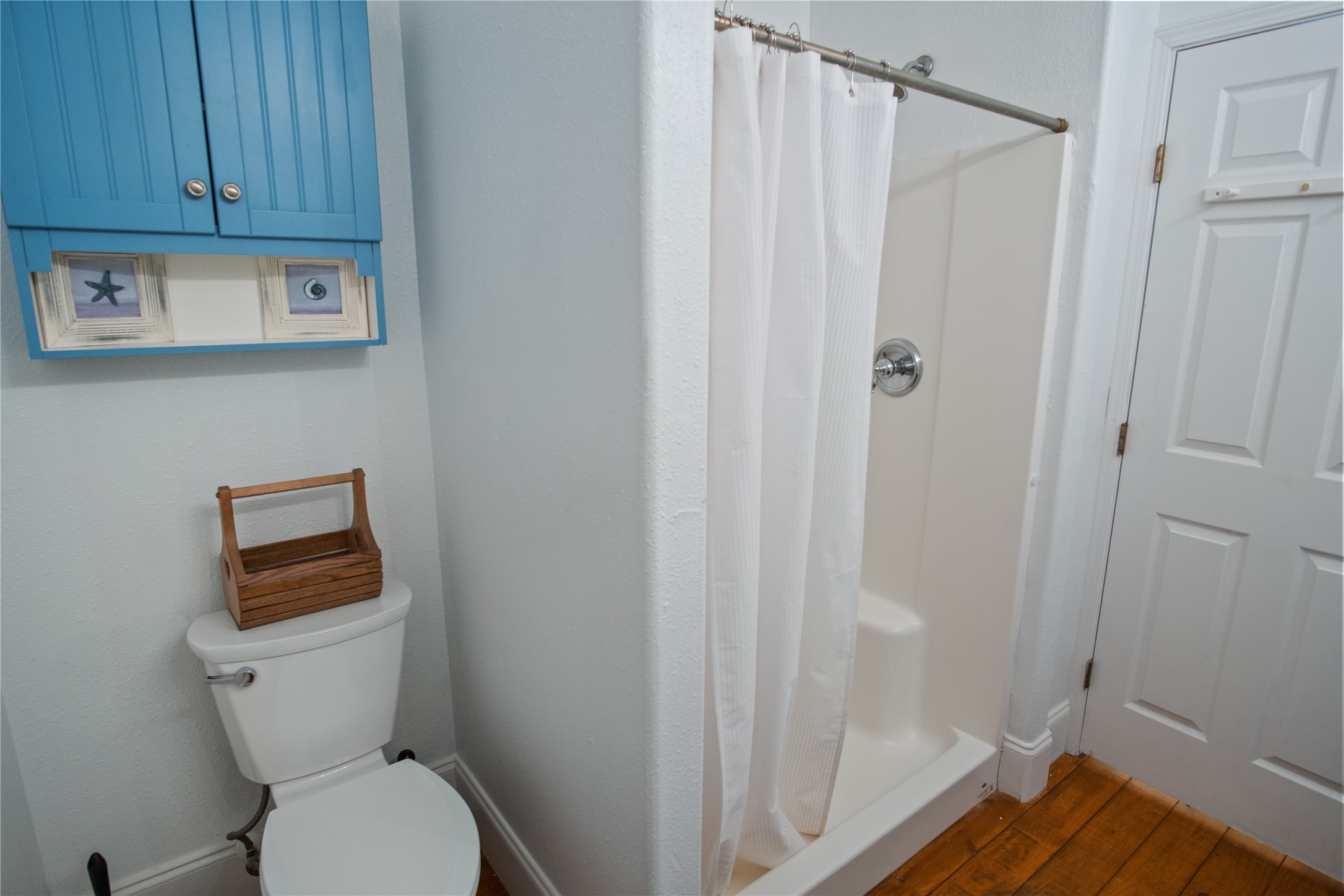 2371 Sandman Crystal Beach, TX 77650 - Photo 26 of 38 a white toilet sitting next to a shower curtain