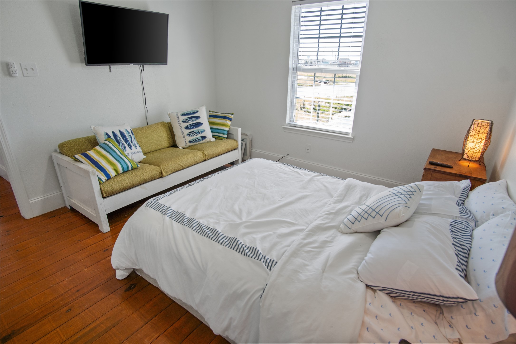 2371 Sandman Crystal Beach, TX 77650 - Photo 32 of 38 a bedroom with a bed a couch and a flat screen tv