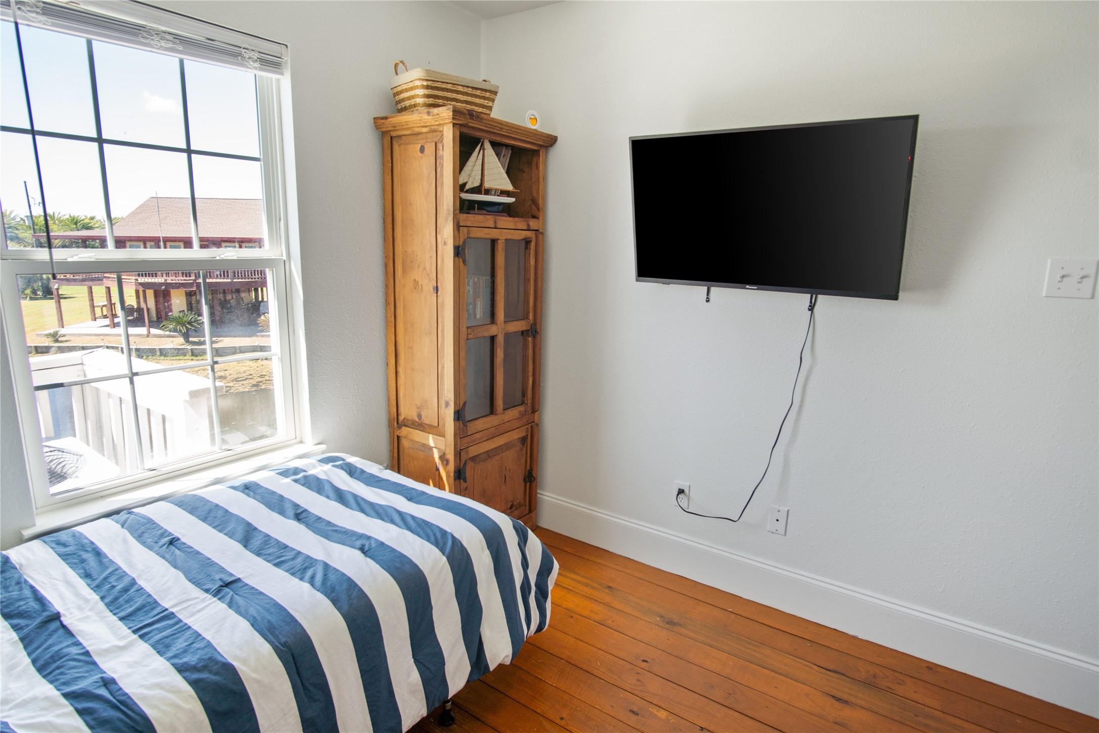 2371 Sandman Crystal Beach, TX 77650 - Photo 37 of 38 a bedroom with a bed tv and a window
