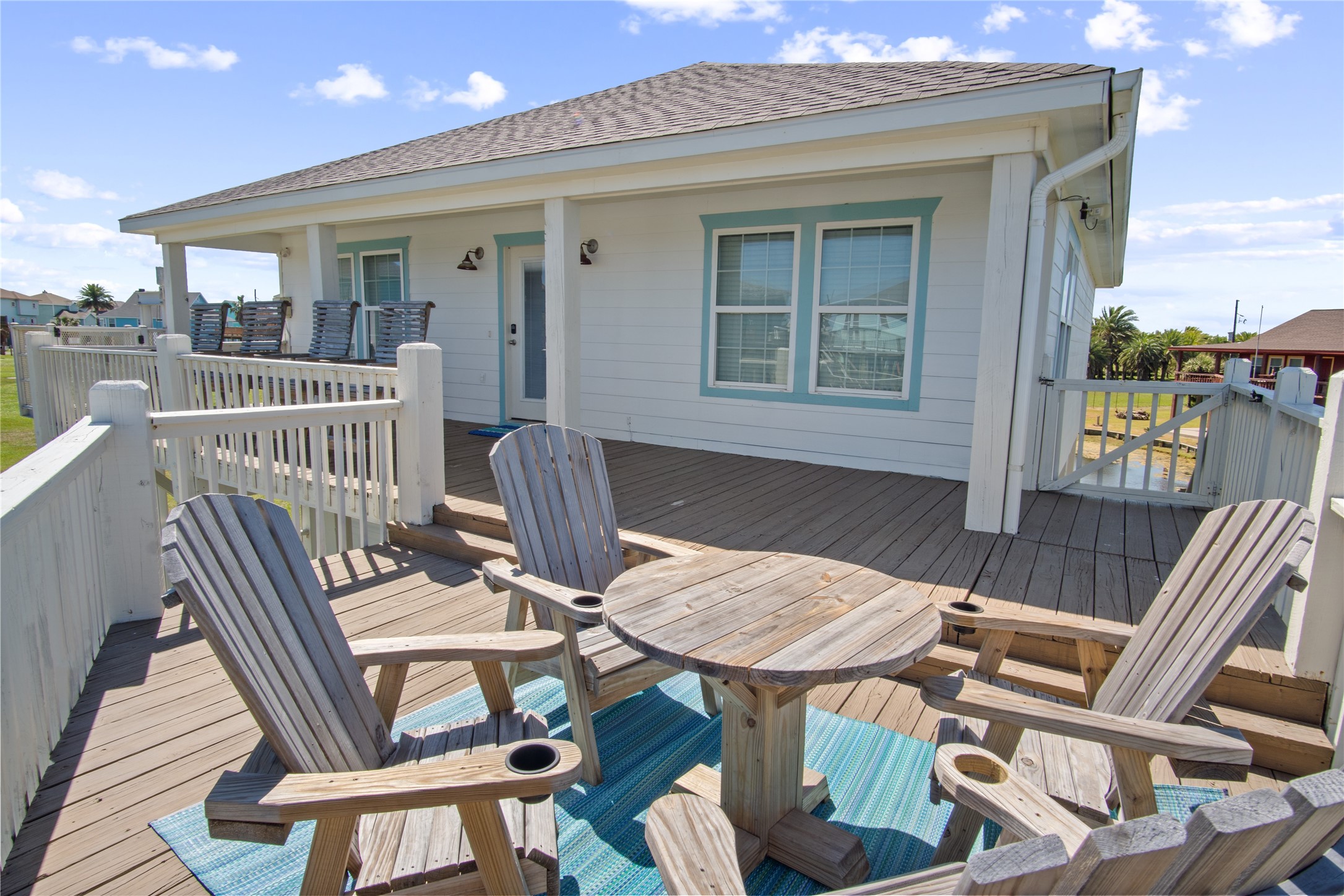 2371 Sandman Crystal Beach, TX 77650 - Photo 10 of 38 a view of a patio with table and chairs with wooden floor and fence