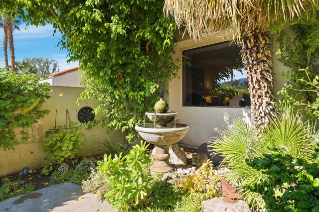 a building outdoor space with patio furniture and potted plants