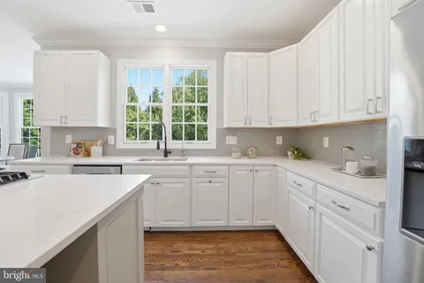 a utility room with sink dryer and washer