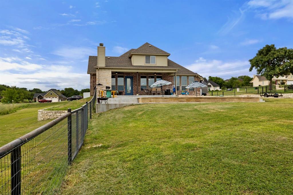 2103 Cash Point Court Granbury, TX 76049 - Photo 34 of 38 a view of a lake with a house in the background