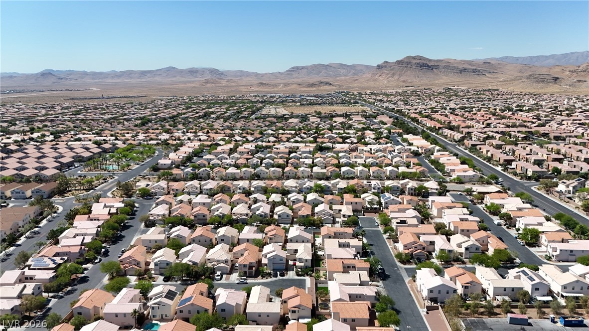 8934 Deep Ridge Court Las Vegas, NV 89178 - Photo 36 of 47 An aerial perspective reveals a vast community of homes nestled against distant desert mountains.