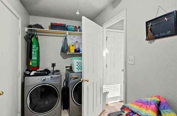 a view of a bedroom with washer and dryer