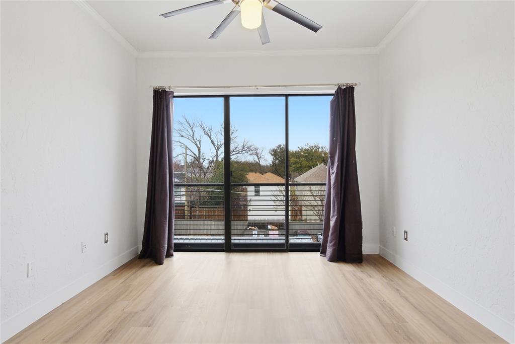 4414 Cedar Springs Road, Unit 312 Dallas, TX 75219 - Photo 14 of 30 an empty room with sliding glass door