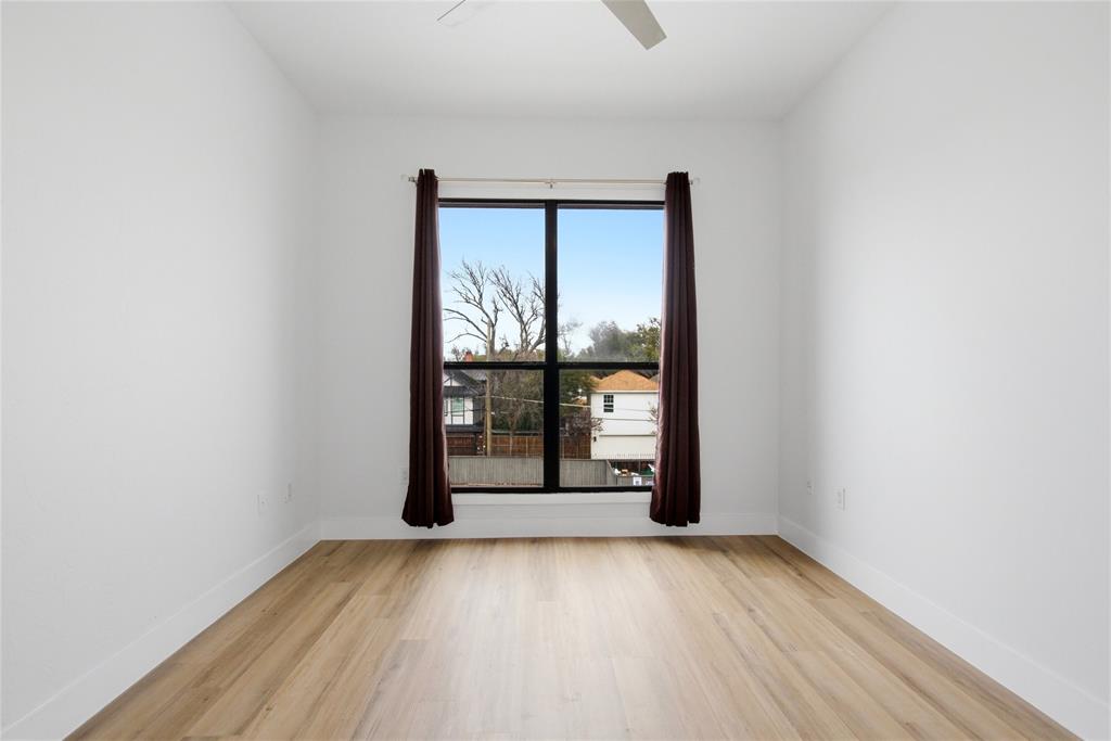 4414 Cedar Springs Road, Unit 312 Dallas, TX 75219 - Photo 19 of 30 wooden floor in an empty room with a window