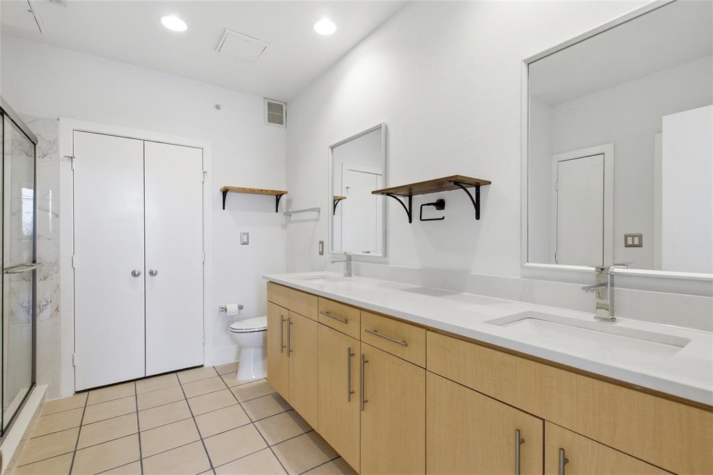 4414 Cedar Springs Road, Unit 312 Dallas, TX 75219 - Photo 22 of 30 a bathroom with a sink and a mirror