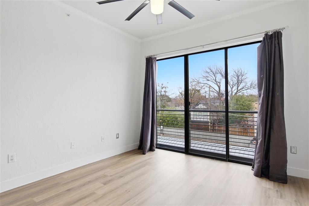4414 Cedar Springs Road, Unit 312 Dallas, TX 75219 - Photo 23 of 30 an empty room with sliding glass door and mountain view