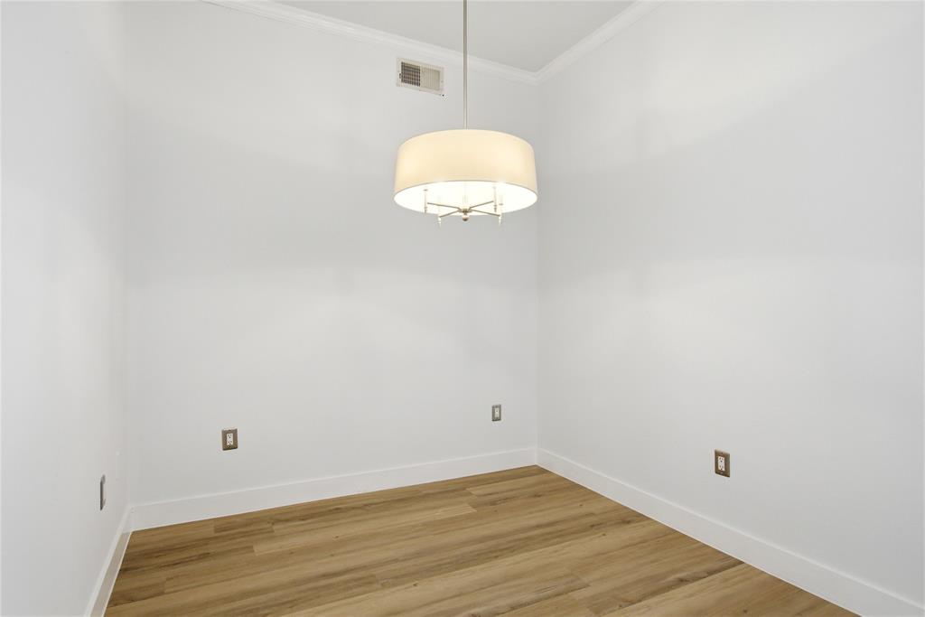 4414 Cedar Springs Road, Unit 312 Dallas, TX 75219 - Photo 29 of 30 a view of a small space with wooden floor and a window