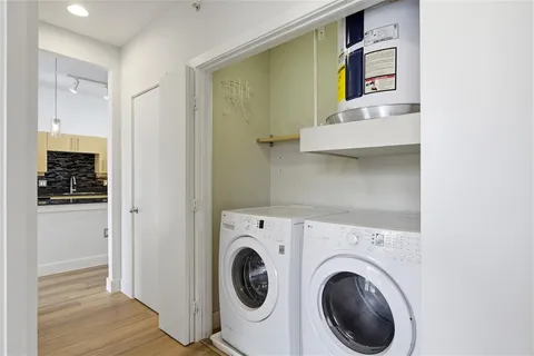 a view of washer and dryer with wooden floor