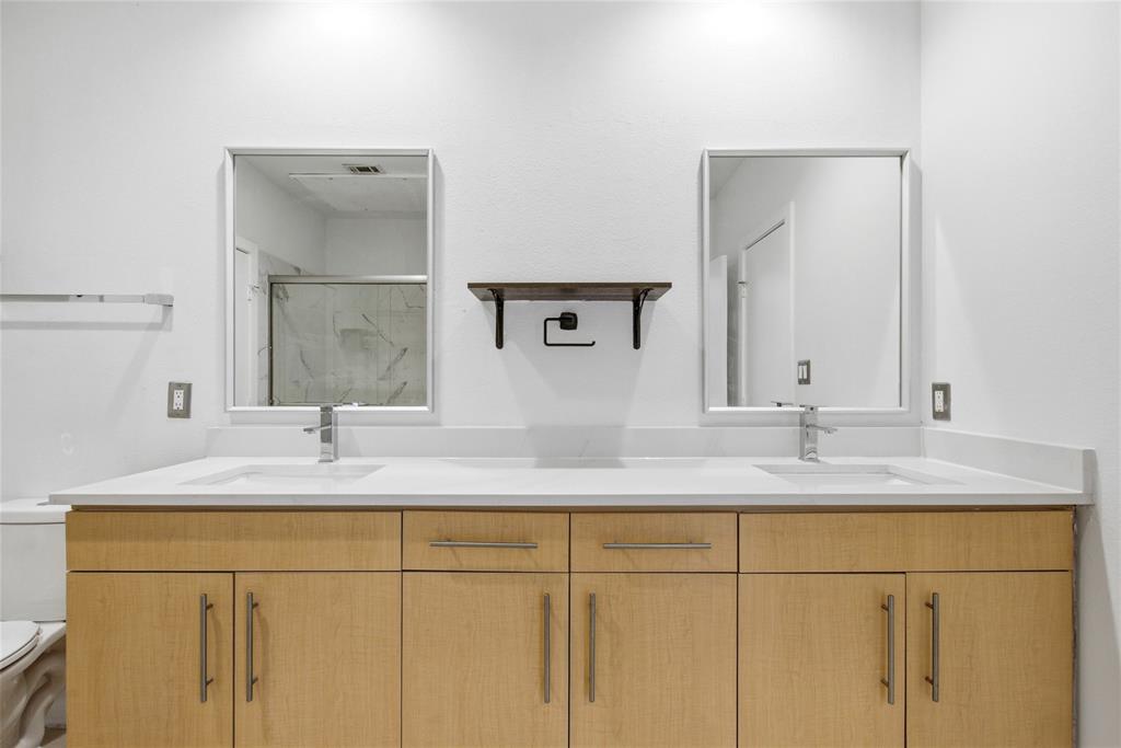 4414 Cedar Springs Road, Unit 312 Dallas, TX 75219 - Photo 7 of 30 a bathroom with a sink and a mirror