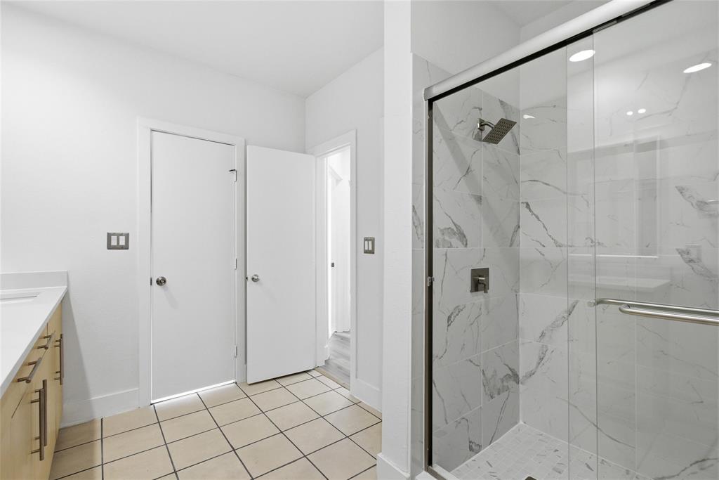 4414 Cedar Springs Road, Unit 312 Dallas, TX 75219 - Photo 8 of 30 a bathroom with a shower and a sink