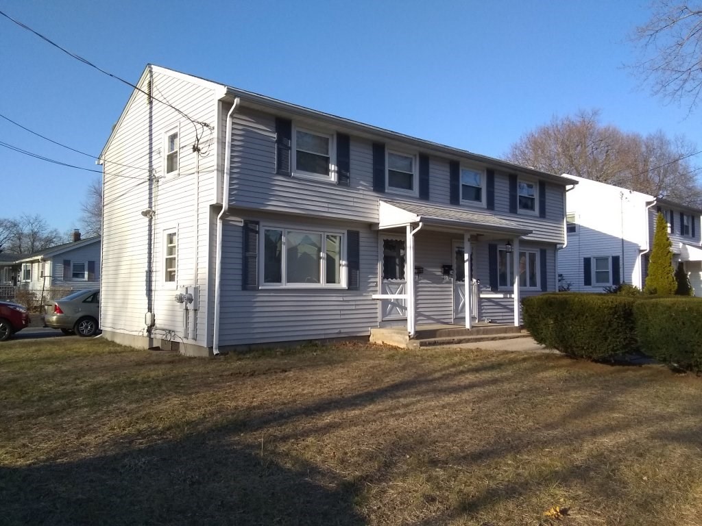 72-74 Tulsa Street Springfield, MA 01118 - Photo 11 of 16 a front view of a house with a yard