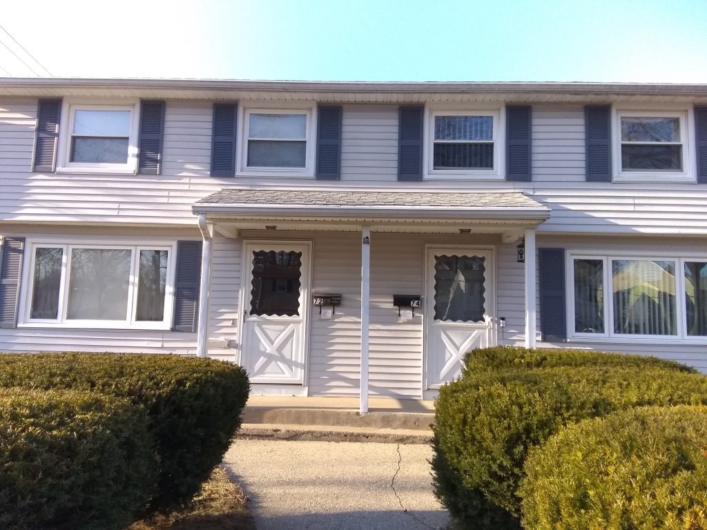 72-74 Tulsa Street Springfield, MA 01118 - Photo 16 of 16 front view of a brick house with a small yard