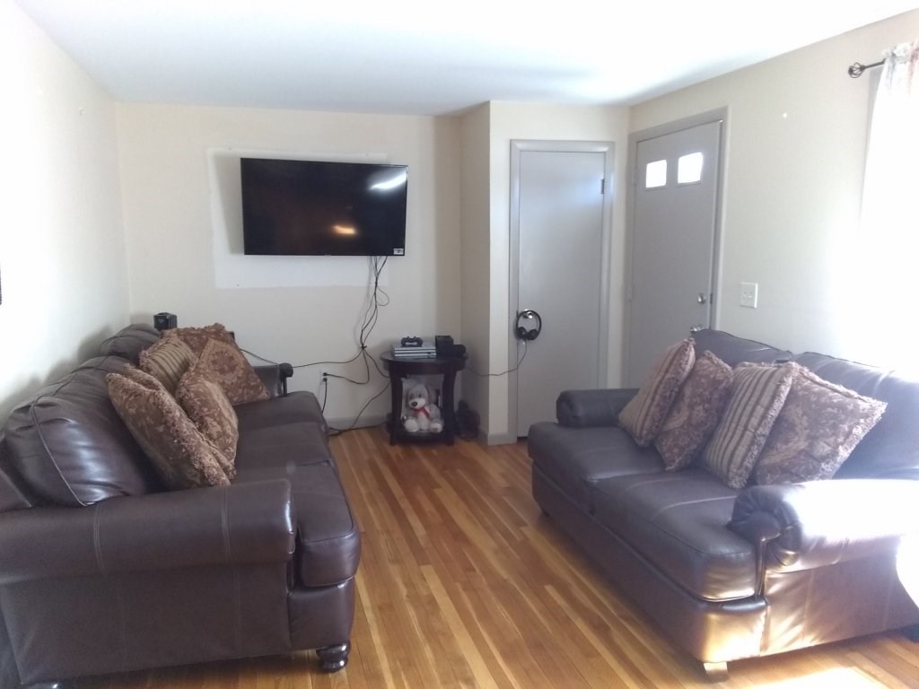 72-74 Tulsa Street Springfield, MA 01118 - Photo 2 of 16 a living room with furniture and a flat screen tv