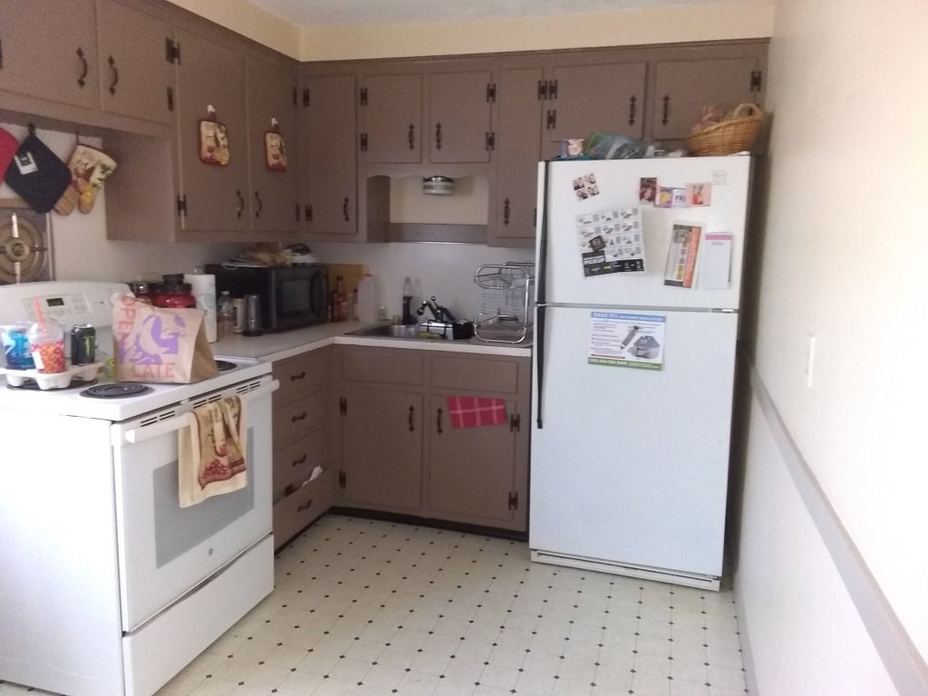 72-74 Tulsa Street Springfield, MA 01118 - Photo 4 of 16 a kitchen with a refrigerator a stove and cabinets