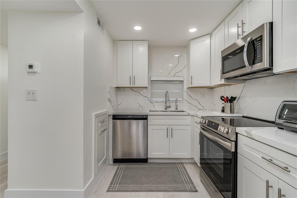 411 South Hollybrook Drive, Unit 109 Pembroke Pines, FL 33025 - Photo 11 of 61 a kitchen with stainless steel appliances granite countertop a sink stove and microwave
