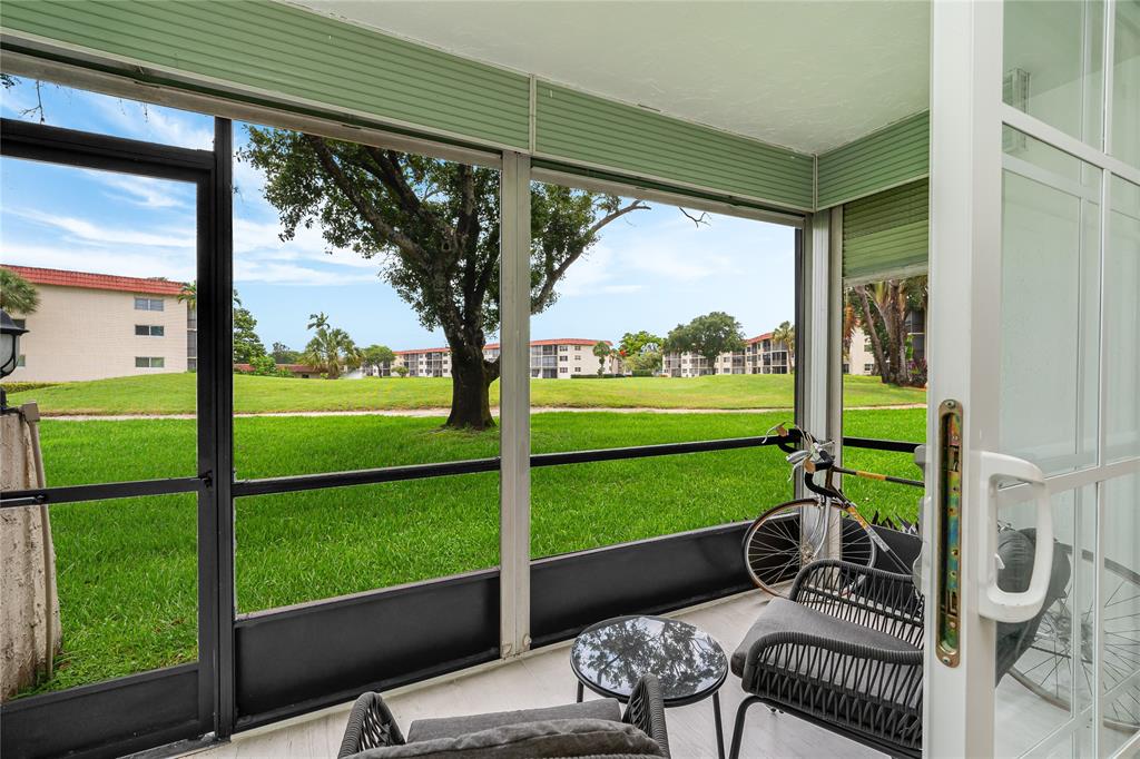 411 South Hollybrook Drive, Unit 109 Pembroke Pines, FL 33025 - Photo 21 of 61 a view of a porch with furniture and garden