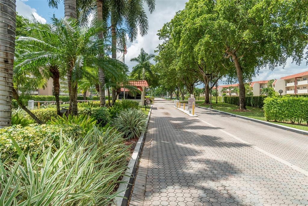 411 South Hollybrook Drive, Unit 109 Pembroke Pines, FL 33025 - Photo 59 of 61 a pathway of a yard