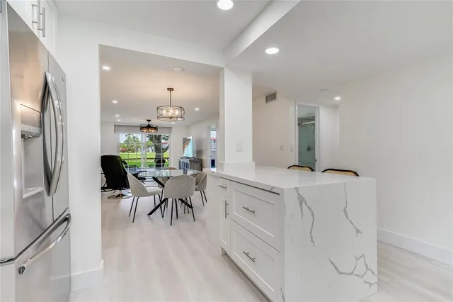 a kitchen with stainless steel appliances a sink and a refrigerator