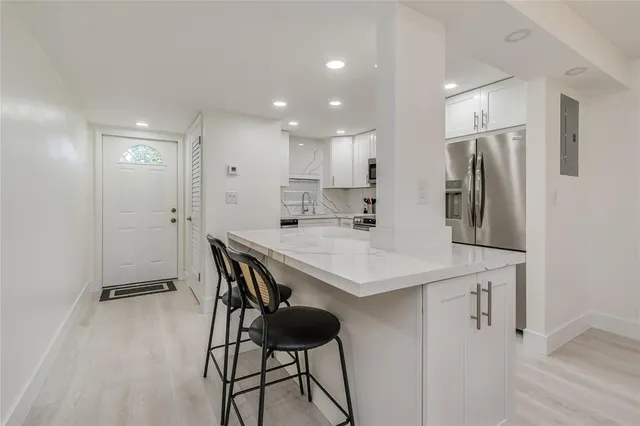 a kitchen with stainless steel appliances granite countertop a sink stove and microwave