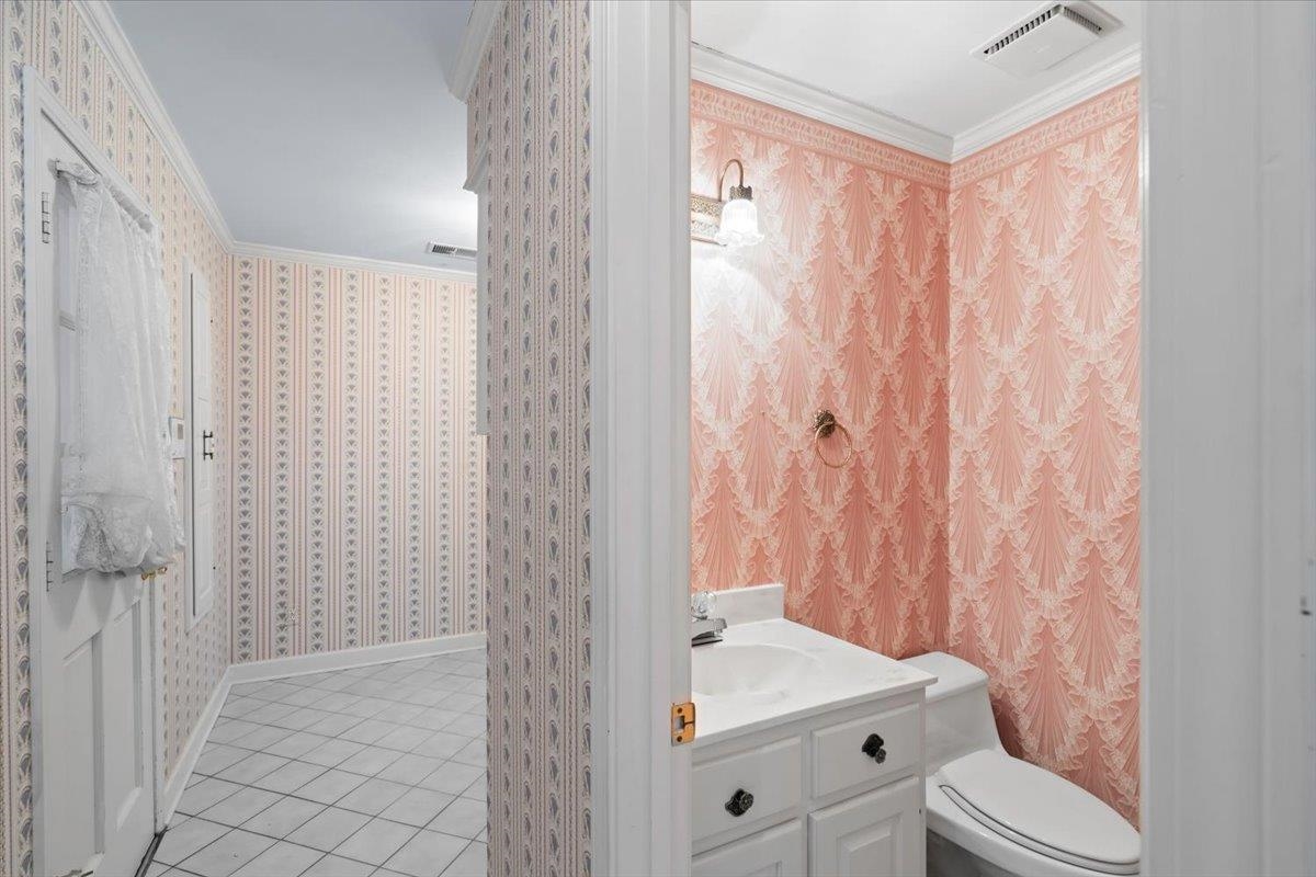 5710 Herald Square Memphis, TN 38120 - Photo 19 of 31 Bathroom featuring toilet, vanity, tile patterned floors, and ornamental molding