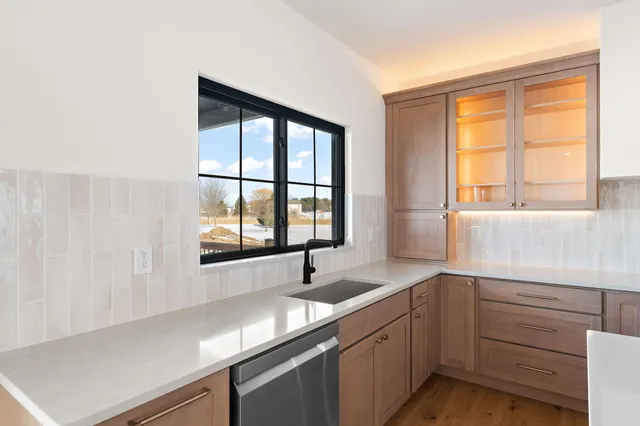 a kitchen with a sink and large window