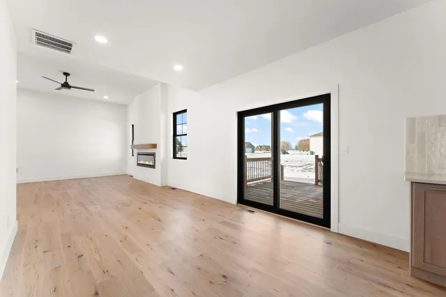 an empty room with windows and closet