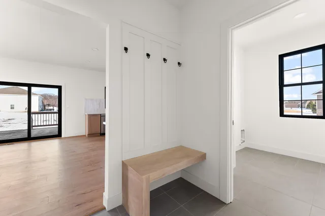 a view of an empty room with window and bathroom