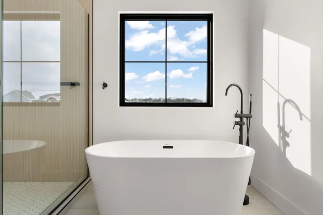 a bathroom with a tub and a window