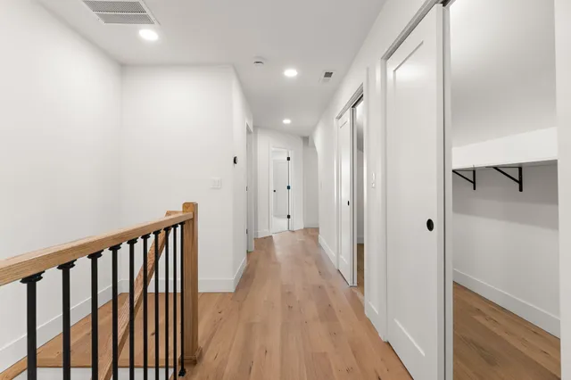 an empty room with windows and cabinet