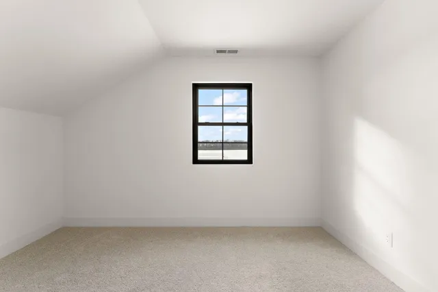 an empty room with windows and ceiling fan
